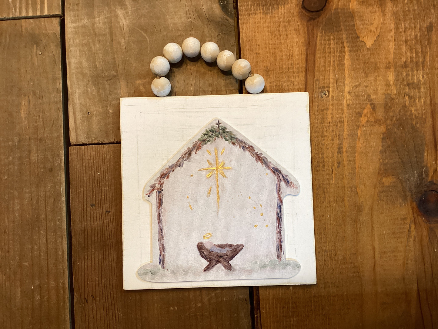 Wooden baby in manger ornament